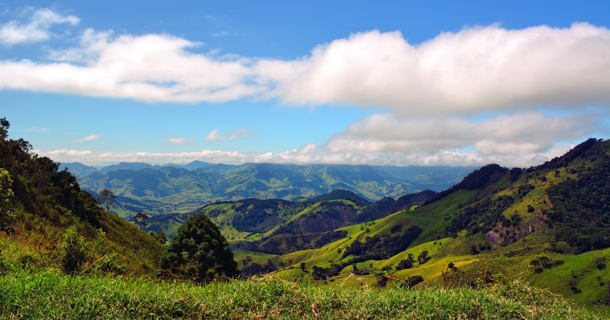 a scenic view of a valley with mountains in the background — Clube Prime, Empório Família Rodrigues